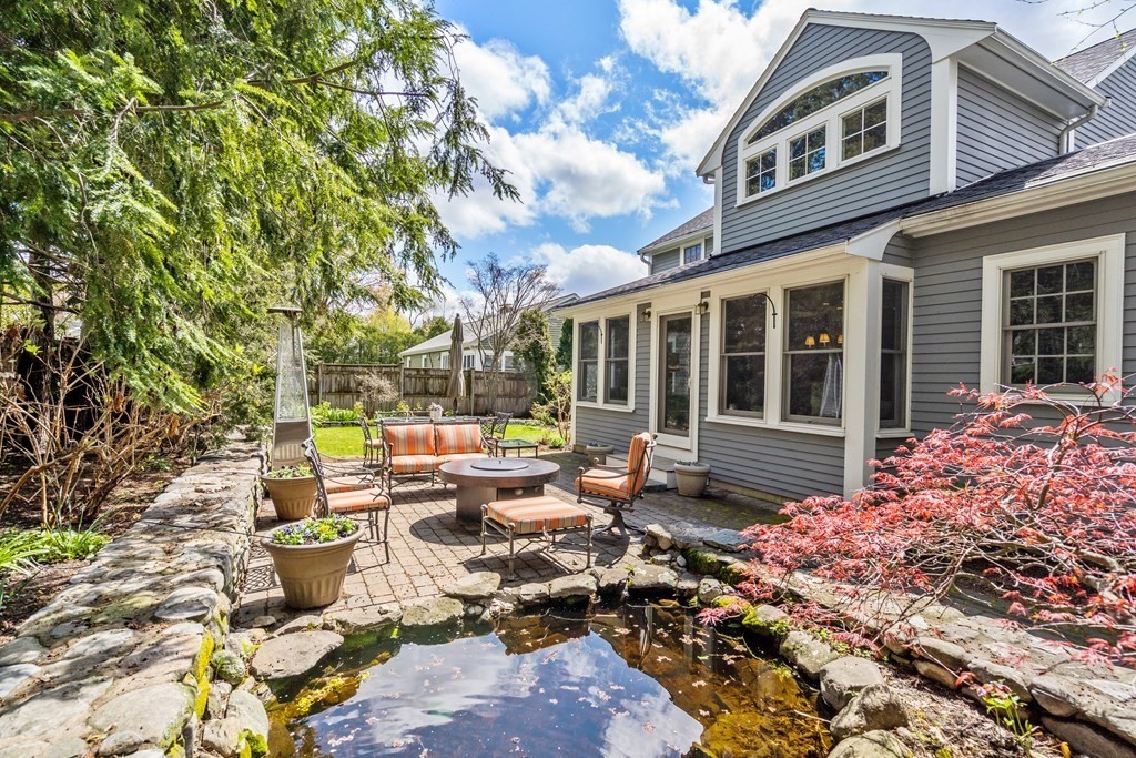 74 Shaw Road Belmont, MA 02478 - Photo 24 of 31 a view of house with yard outdoor seating and covered with plants