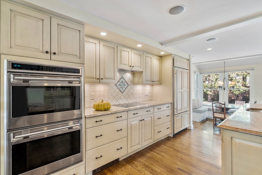 74 Shaw Road Belmont, MA 02478 - Photo 7 of 31 a kitchen with granite countertop cabinets stainless steel appliances and wooden floor
