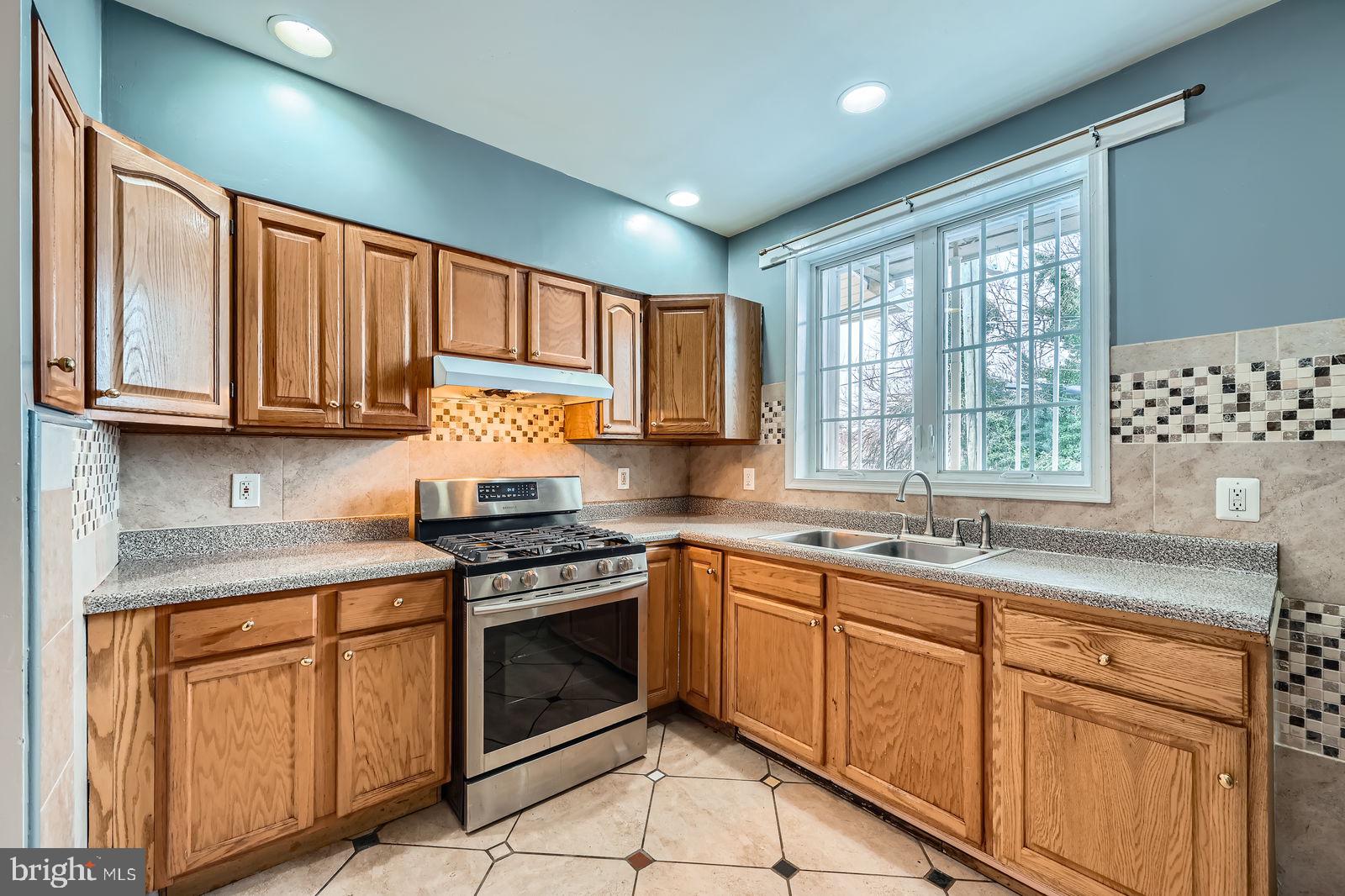 2015 East North Avenue Baltimore, MD 21213 - Photo 12 of 34 a kitchen with granite countertop stainless steel appliances white cabinets granite counter tops and a window