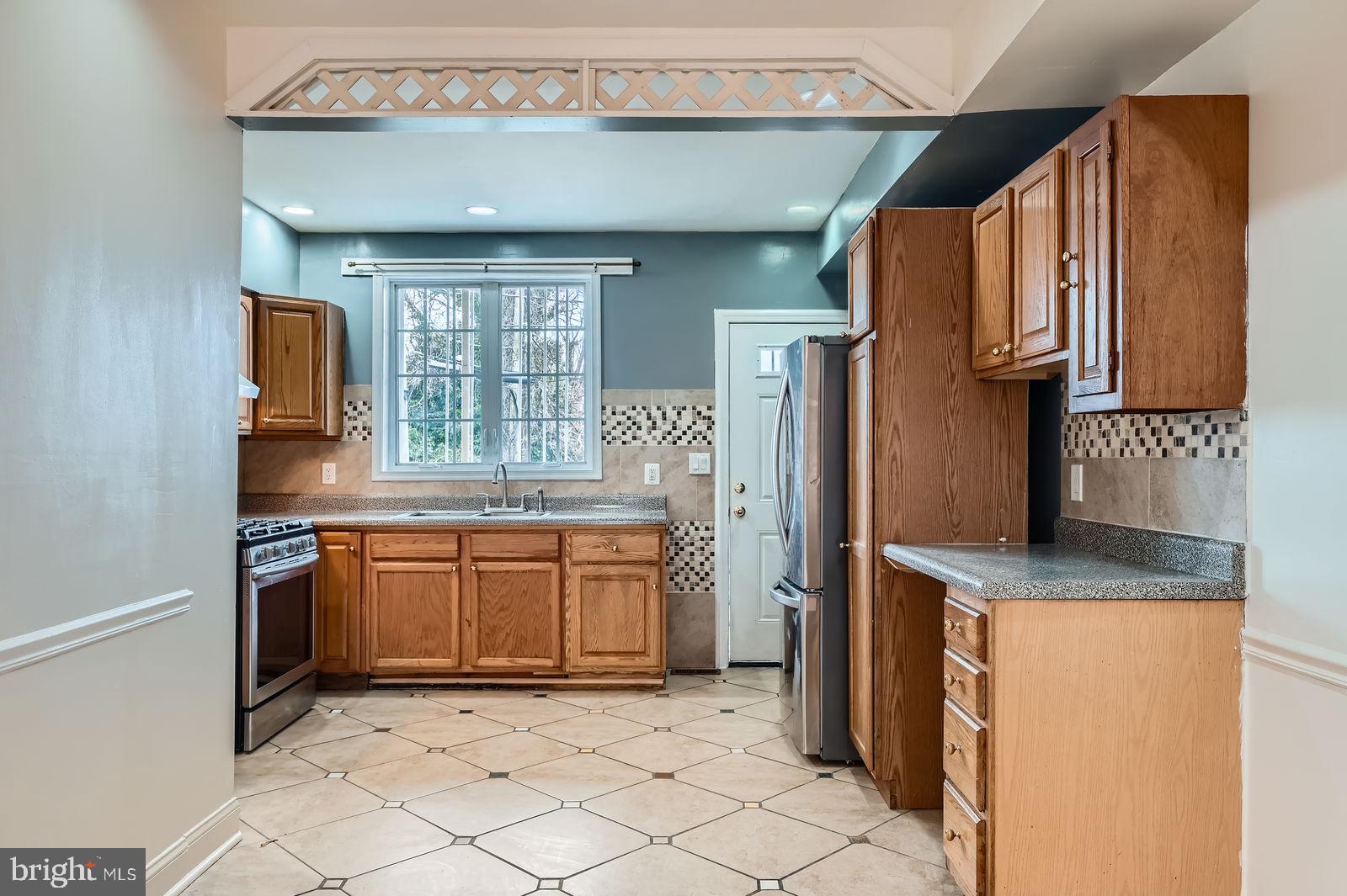 2015 East North Avenue Baltimore, MD 21213 - Photo 14 of 34 a kitchen with stainless steel appliances granite countertop a refrigerator and a sink