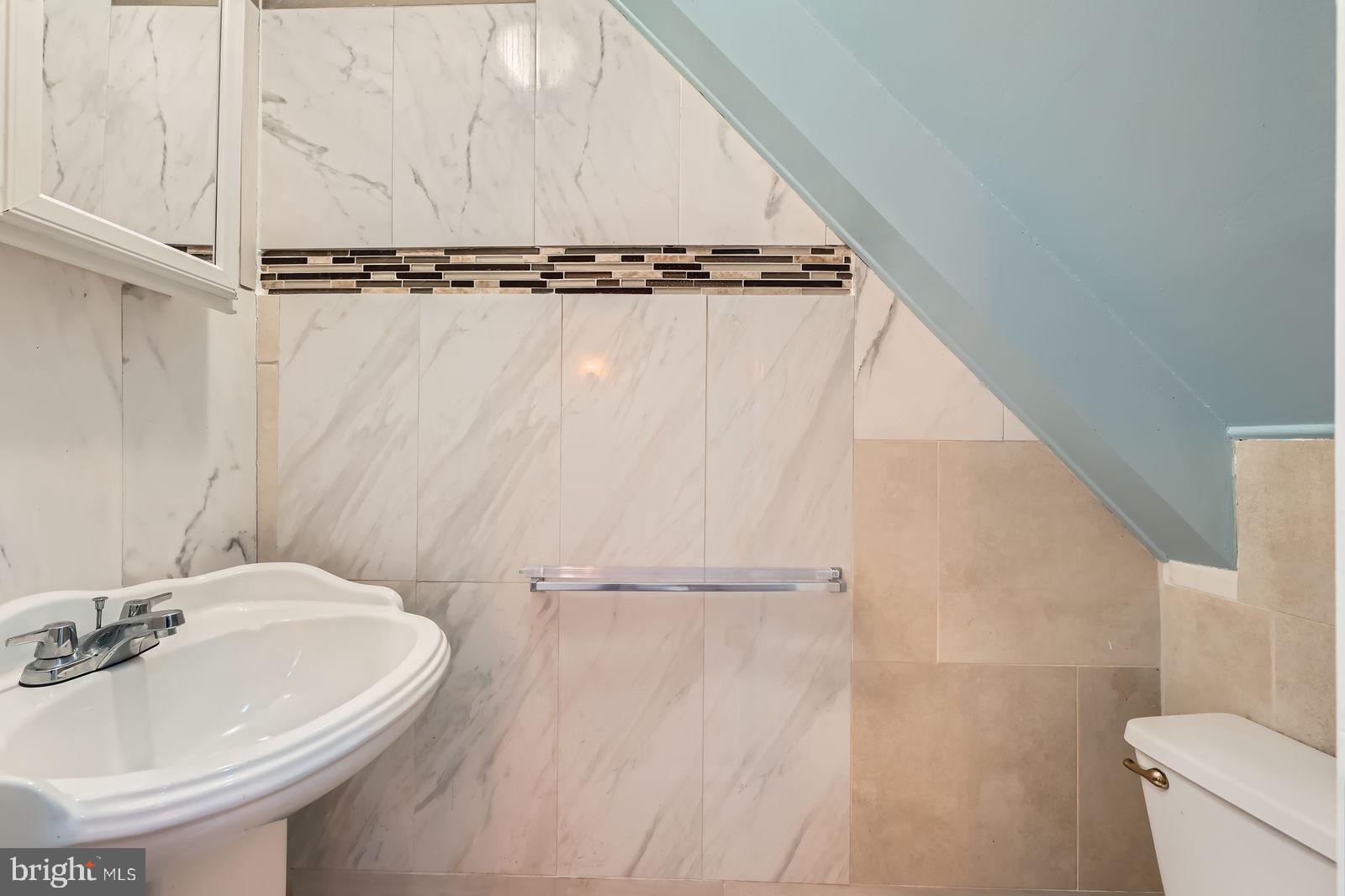 2015 East North Avenue Baltimore, MD 21213 - Photo 15 of 34 a bathroom with a sink and mirror with toilet