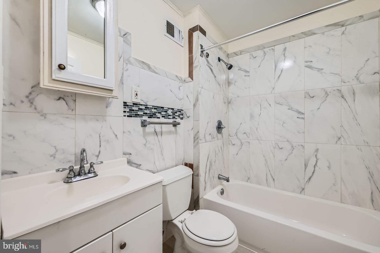 2015 East North Avenue Baltimore, MD 21213 - Photo 16 of 34 a bathroom with a sink a toilet and a bathtub