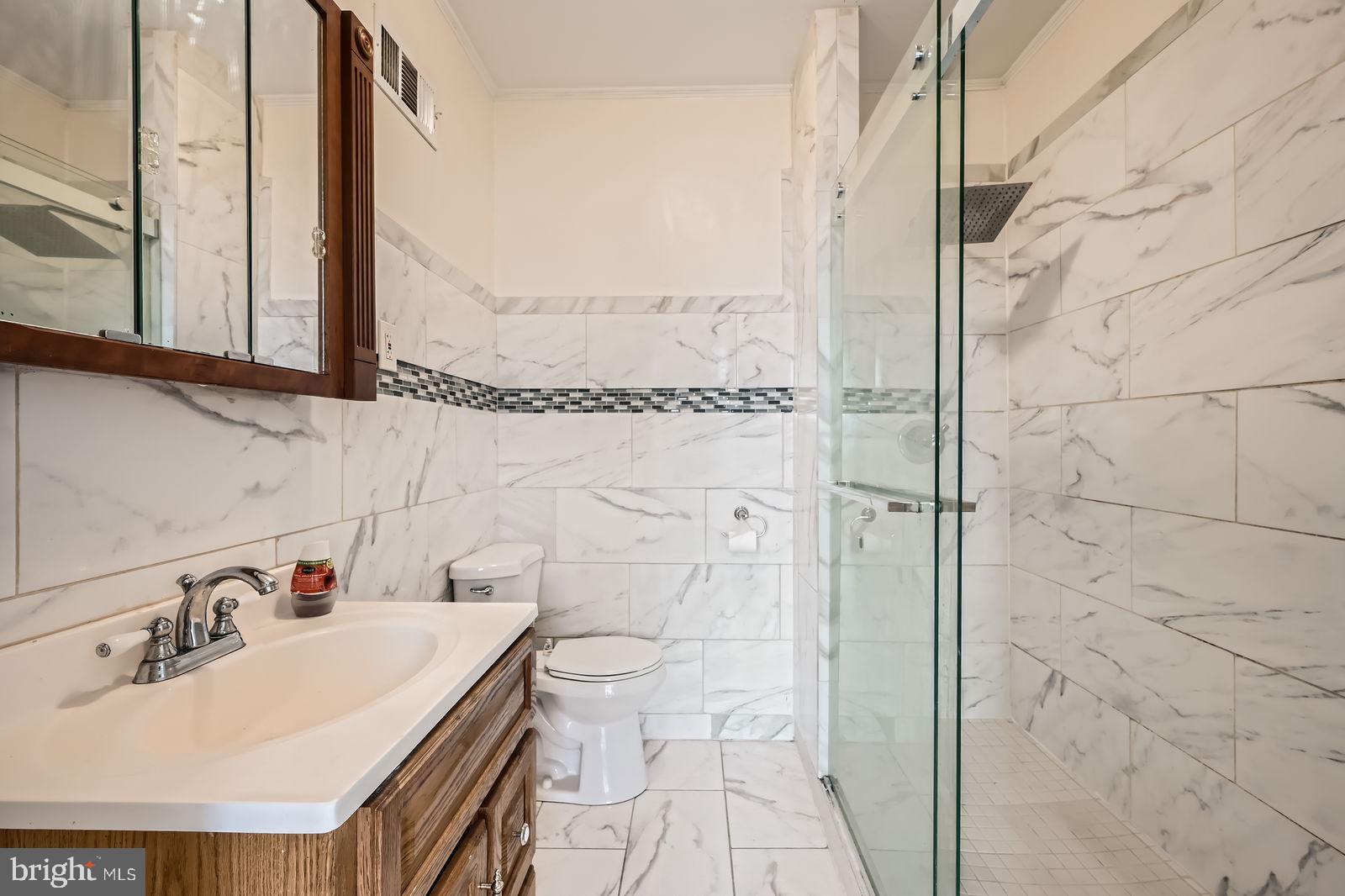 2015 East North Avenue Baltimore, MD 21213 - Photo 20 of 34 a bathroom with a sink a toilet and shower