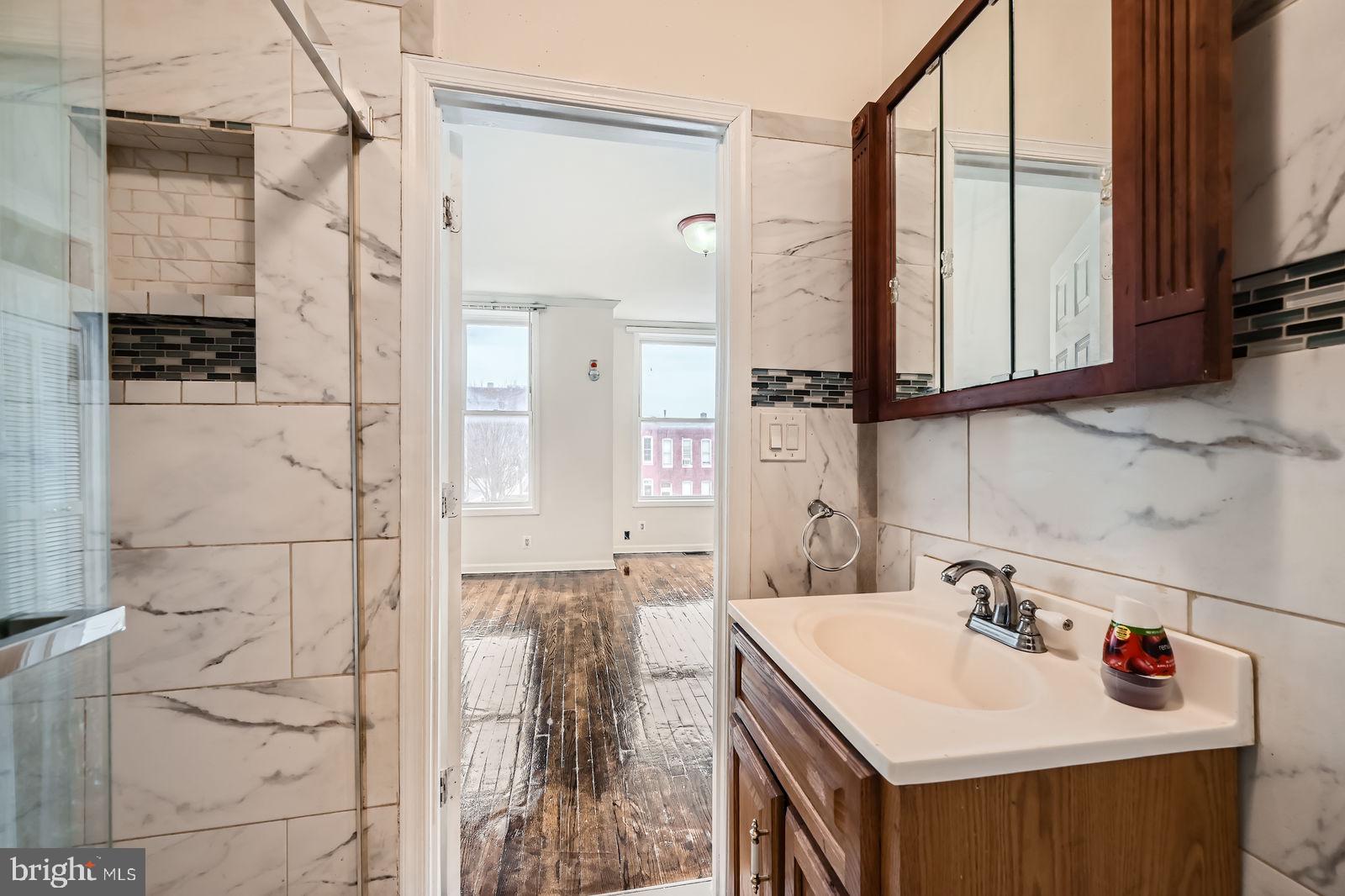 2015 East North Avenue Baltimore, MD 21213 - Photo 22 of 34 a bathroom with a sink vanity and a mirror