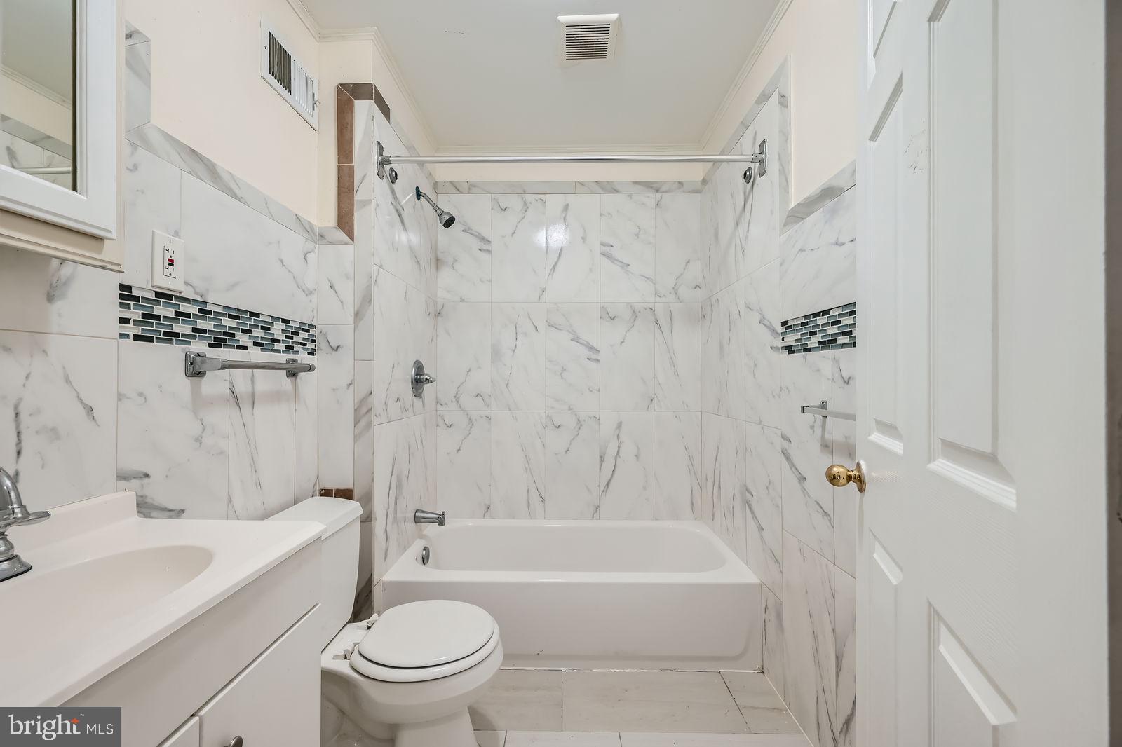 2015 East North Avenue Baltimore, MD 21213 - Photo 24 of 34 a bathroom with a sink a toilet and a bathtub