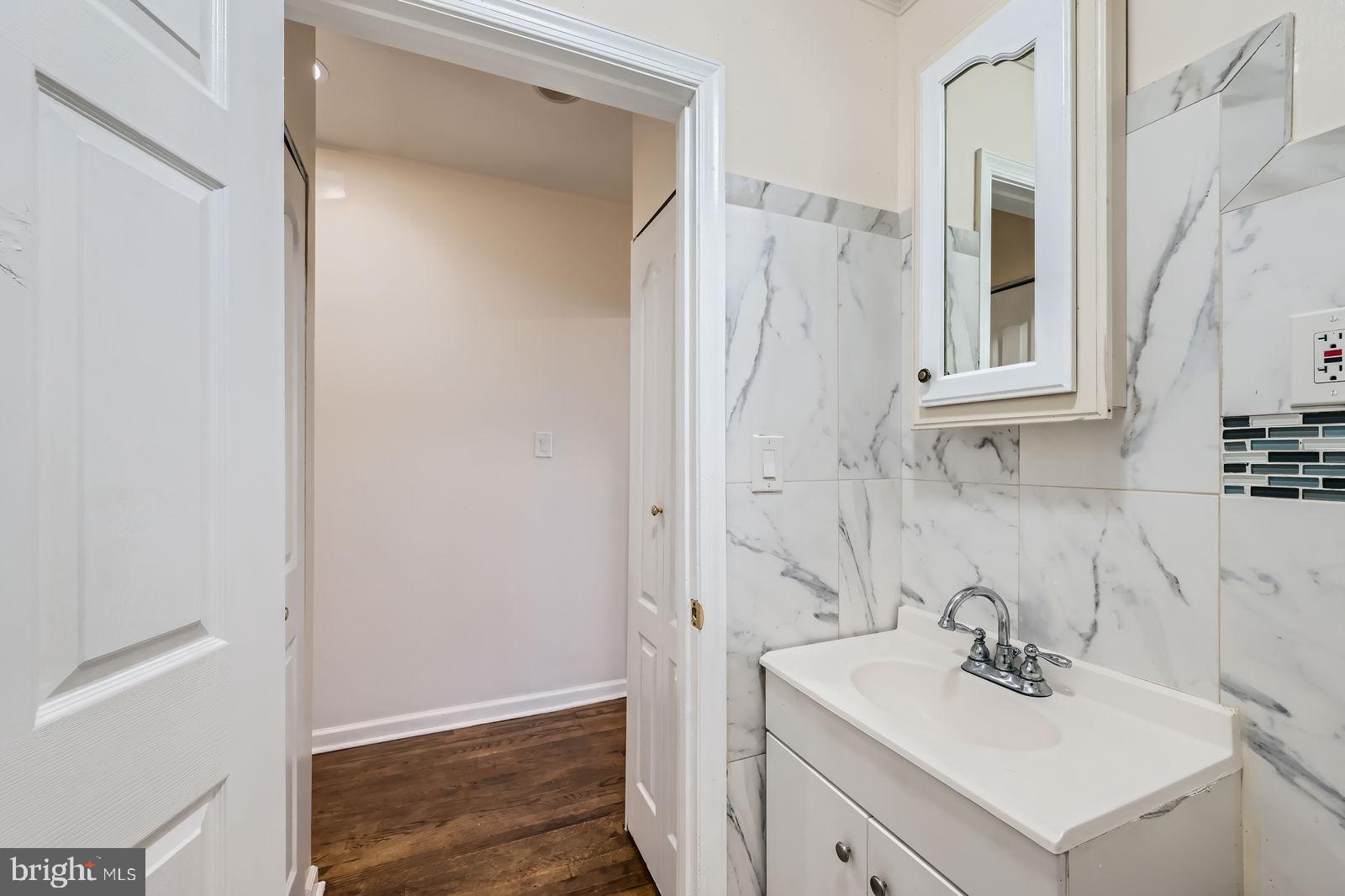 2015 East North Avenue Baltimore, MD 21213 - Photo 25 of 34 a bathroom with a sink a vanity and a mirror