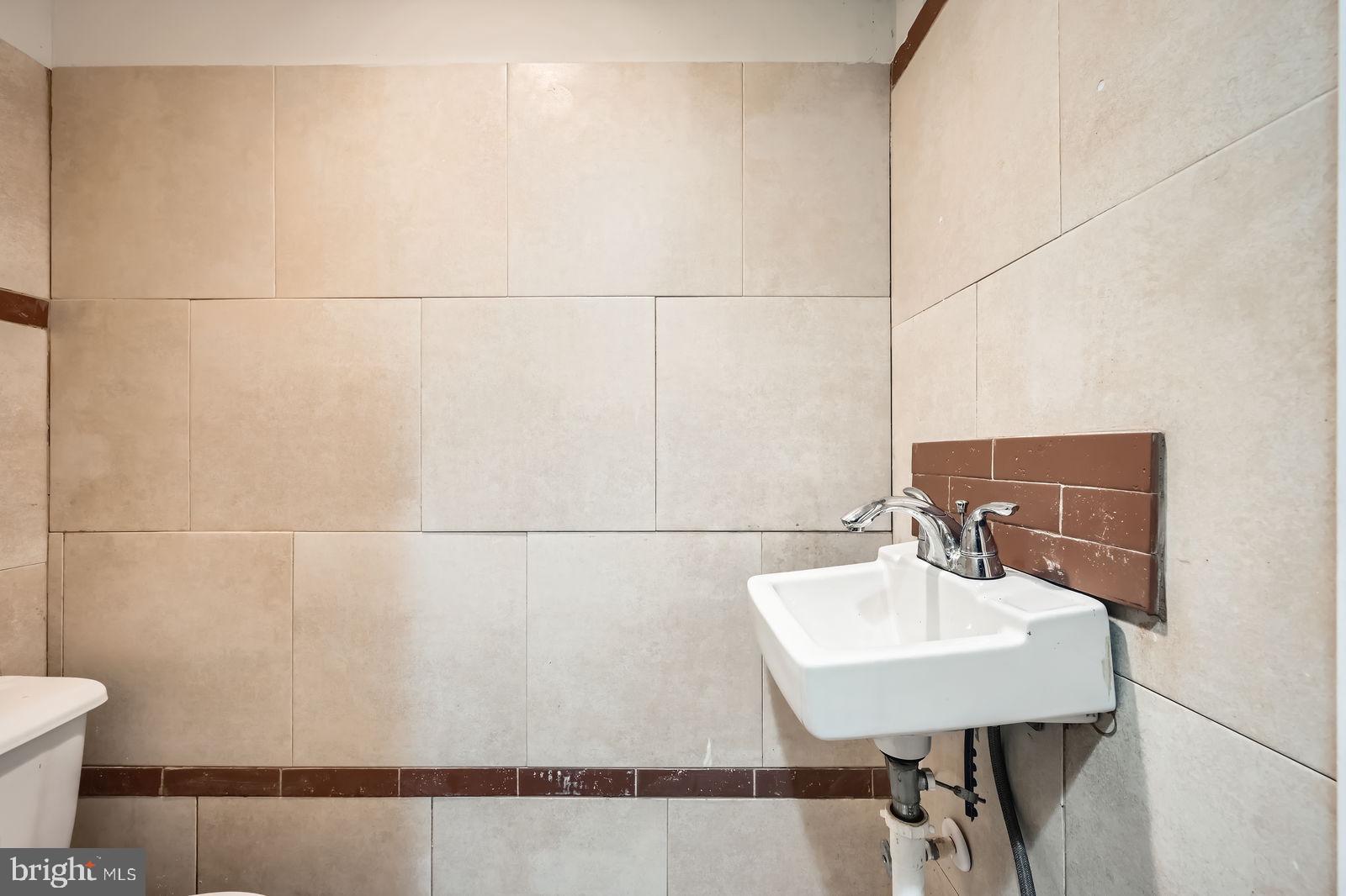 2015 East North Avenue Baltimore, MD 21213 - Photo 31 of 34 a bathroom with a sink toilet and mirror