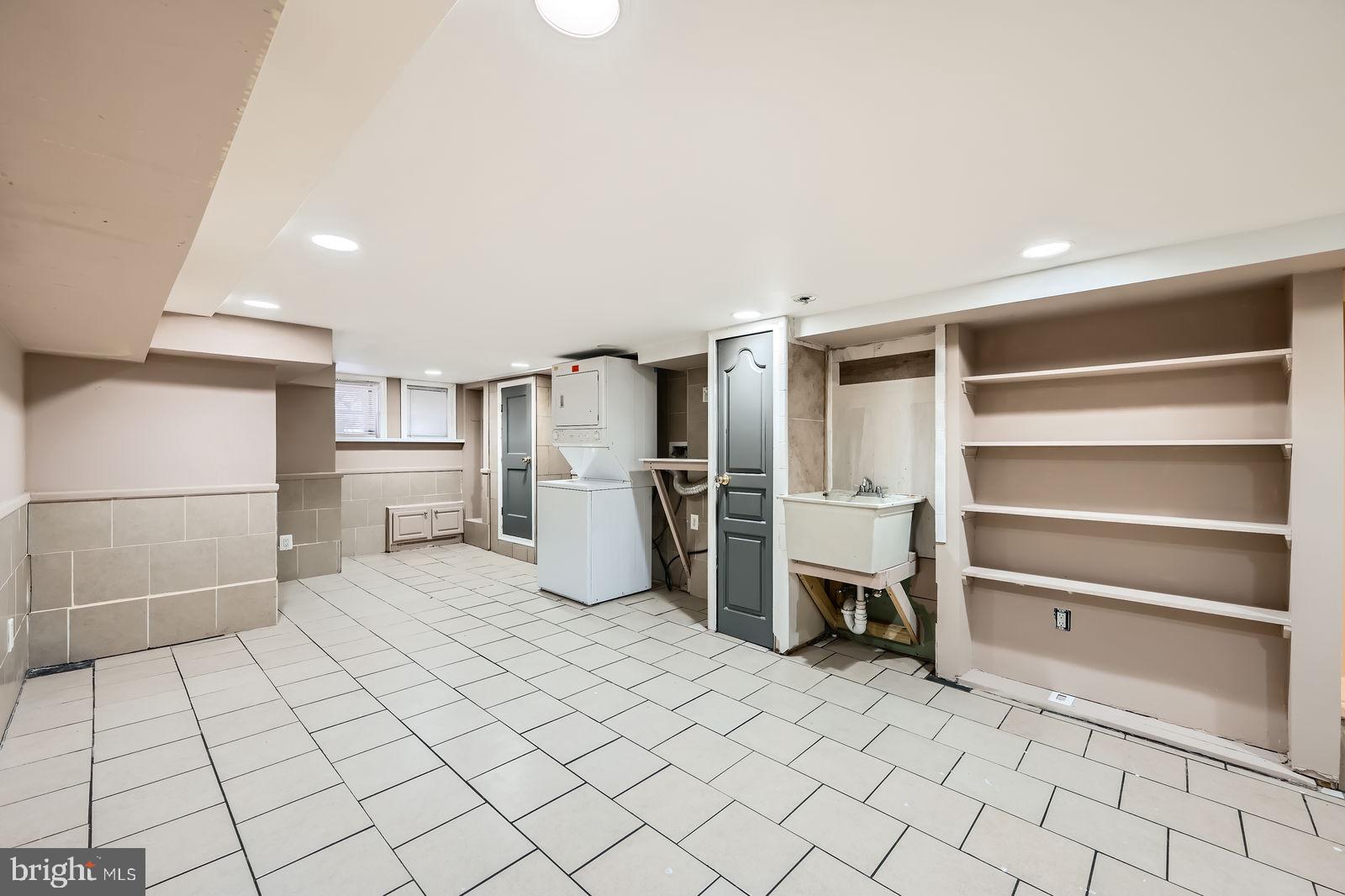 2015 East North Avenue Baltimore, MD 21213 - Photo 32 of 34 a kitchen with white cabinets and refrigerator