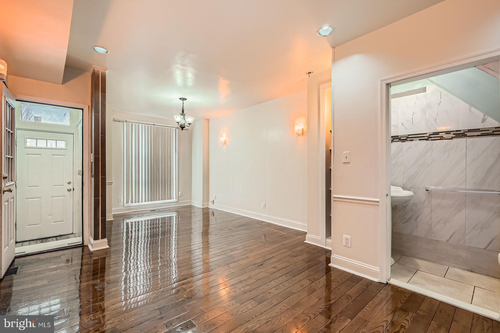 2015 East North Avenue Baltimore, MD 21213 - Photo 4 of 34 an empty room with wooden floor and a bathroom