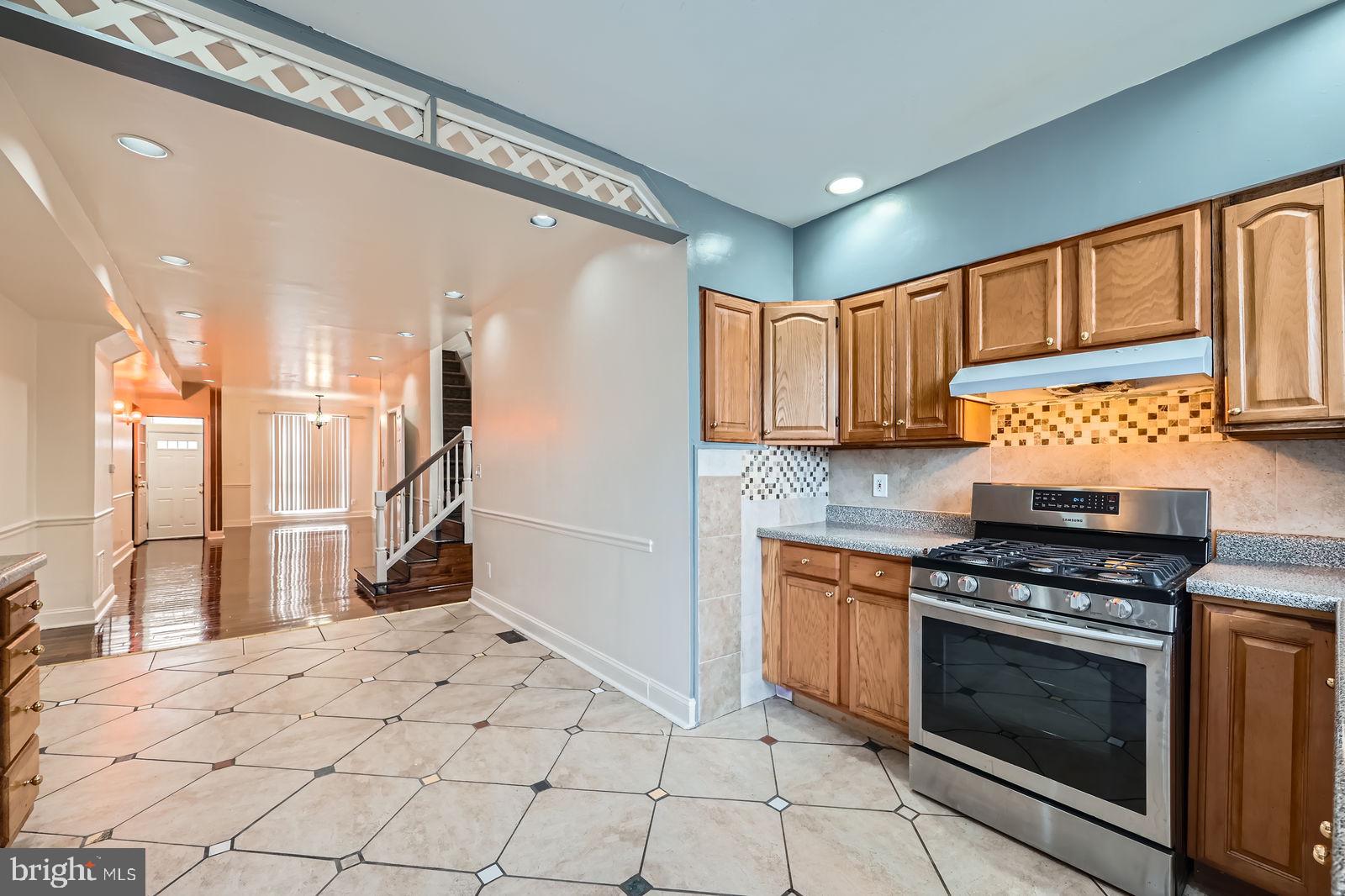 2015 East North Avenue Baltimore, MD 21213 - Photo 9 of 34 a kitchen with stainless steel appliances a stove a sink and a refrigerator
