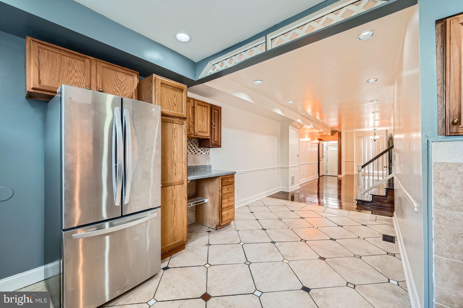 2015 East North Avenue Baltimore, MD 21213 - Photo 10 of 34 a kitchen with stainless steel appliances a refrigerator sink and cabinets