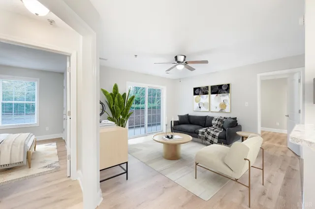a living room with furniture and a potted plant