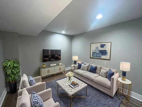 a living room with furniture and a flat screen tv