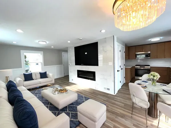 a living room with stainless steel appliances kitchen island granite countertop furniture a dining table and kitchen view