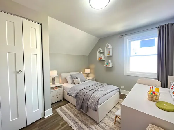 a bedroom with a bed and wooden floor