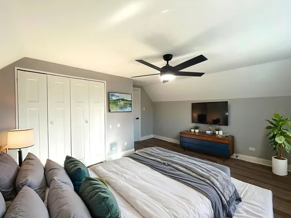 a bedroom with a bed and a flat screen tv