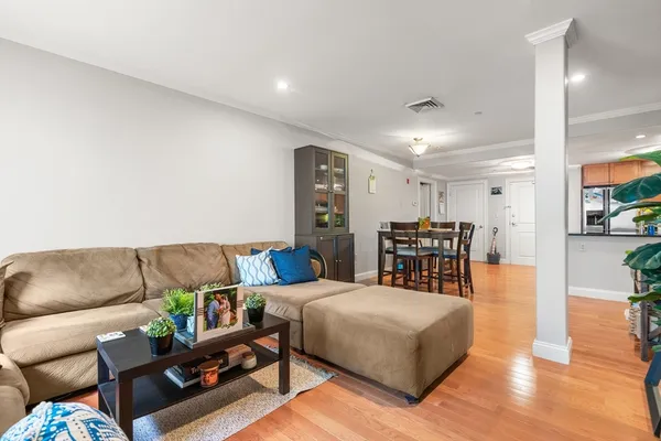 a living room with furniture and a wooden floor