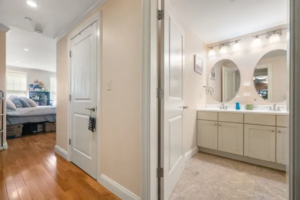 a en suite bathroom with a double vanity sink a mirror and a shower