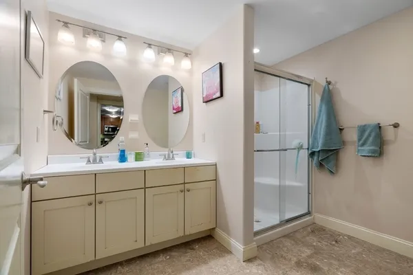 a bathroom with a double vanity sink and a mirror