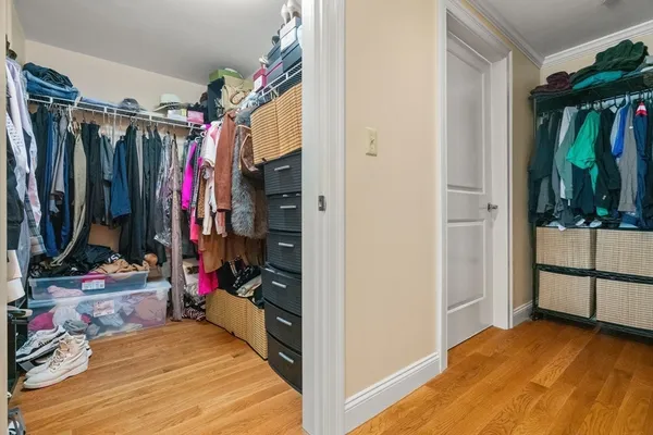 a view of walk in closet with clothes