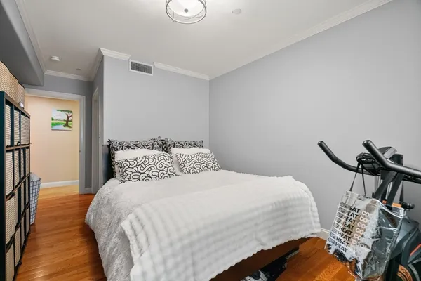 a bedroom with a bed and a chair