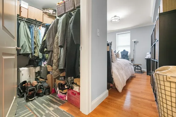 a view of a bedroom with clothes and shoes