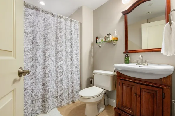 a bathroom with a sink toilet and shower