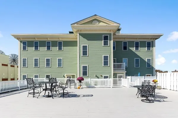 a front view of a house with outdoor seating