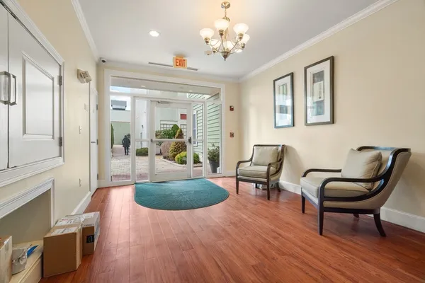 a living room with furniture and a chandelier