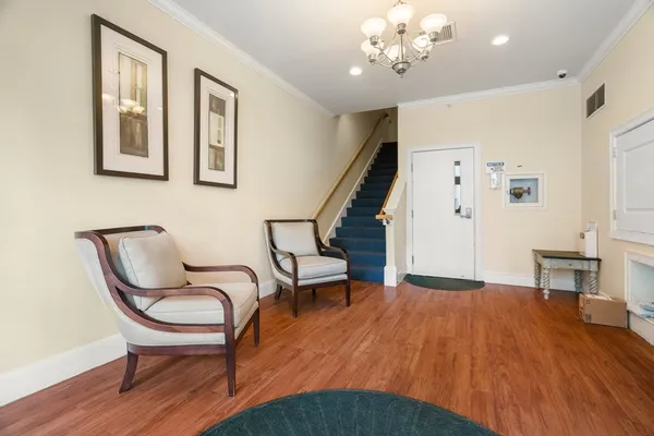 a view of a livingroom with furniture and stairs