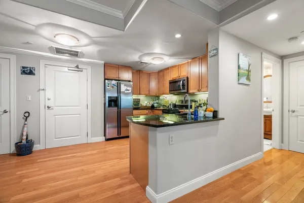 a kitchen with stainless steel appliances granite countertop a refrigerator and a sink
