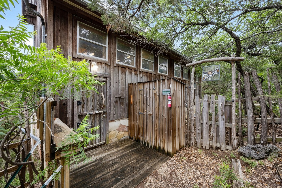 15207 Farm To Market Road 2769 Volente, TX 78641 - Photo 1 of 26 a front view of a house with a garden