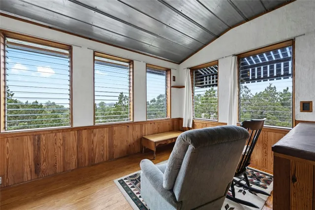 a roof deck with table and chairs