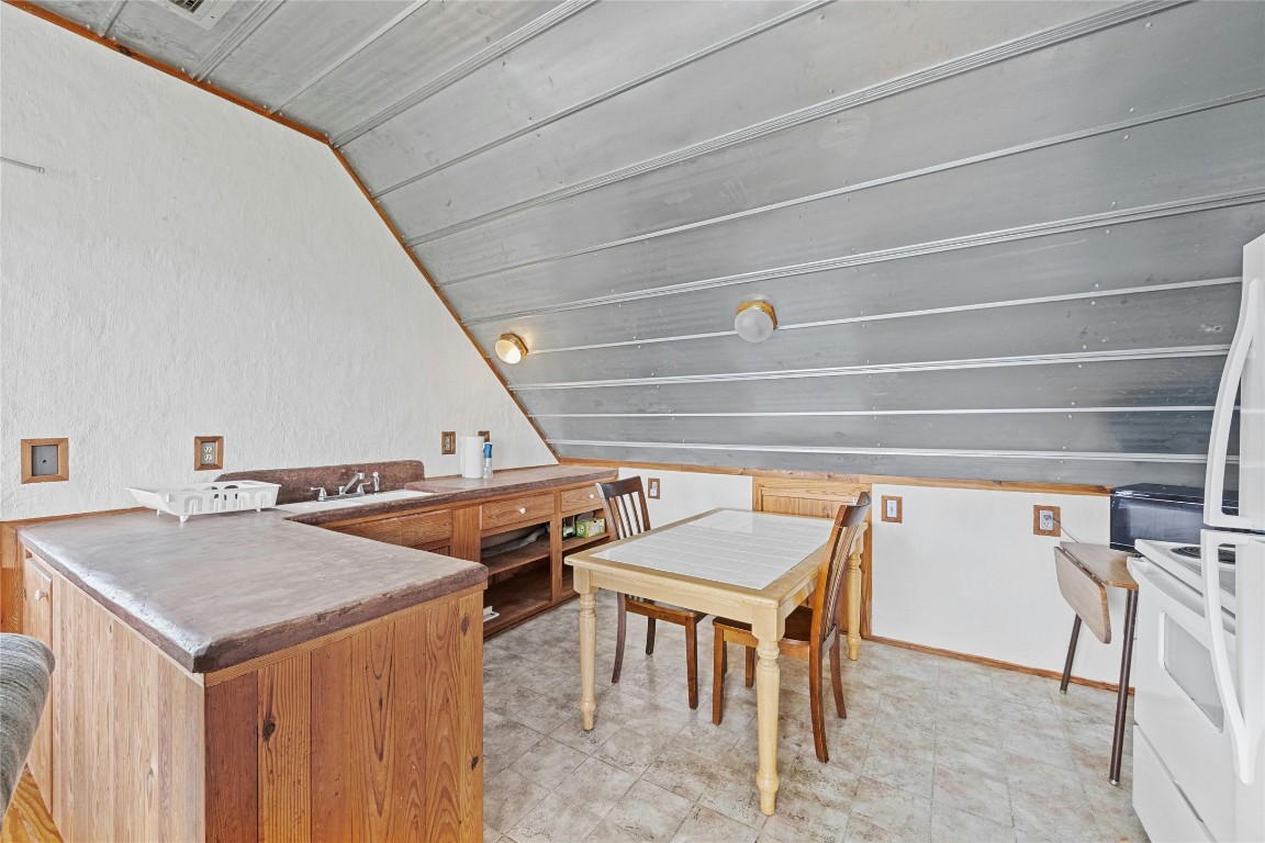 15207 Farm To Market Road 2769 Volente, TX 78641 - Photo 17 of 26 a roof deck with table and chairs