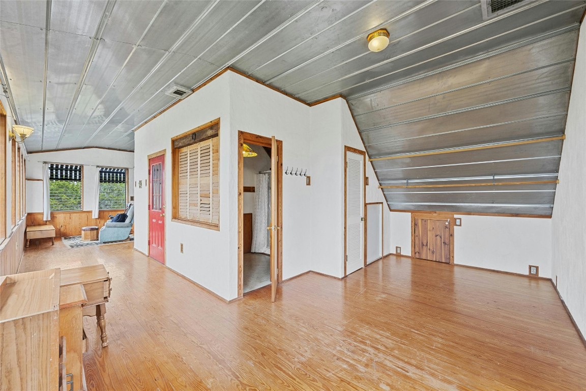 15207 Farm To Market Road 2769 Volente, TX 78641 - Photo 21 of 26 a view of a hallway with wooden floor and furniture
