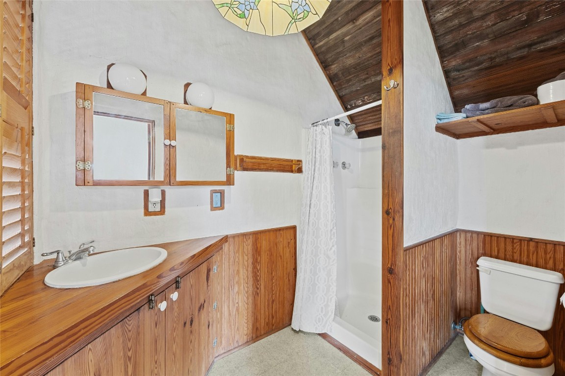 15207 Farm To Market Road 2769 Volente, TX 78641 - Photo 23 of 26 a bathroom with a granite countertop sink toilet and shower