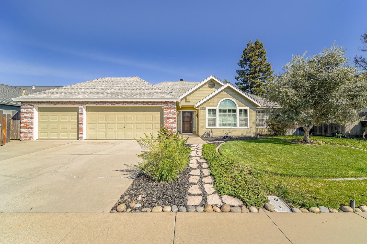 a front view of a house with a garden