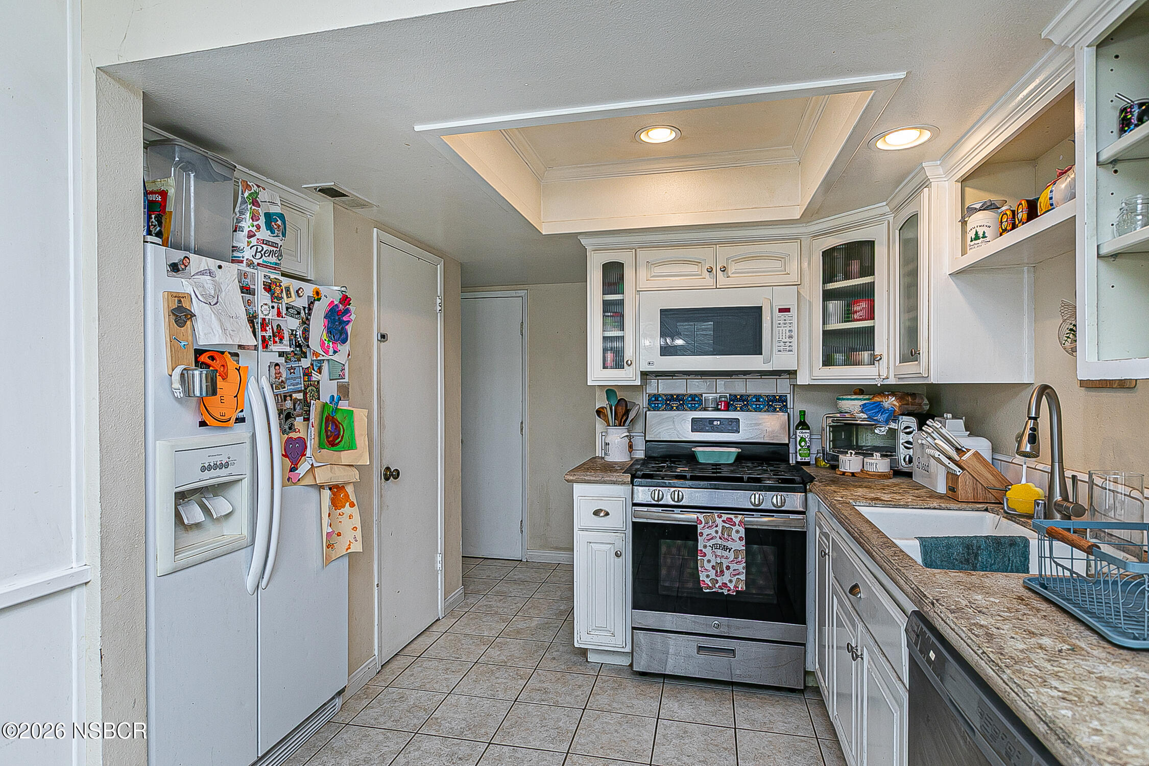 712 Pebble Beach Place Santa Maria, CA 93454 - Photo 11 of 31 a kitchen with stainless steel appliances granite countertop a stove top oven and a refrigerator