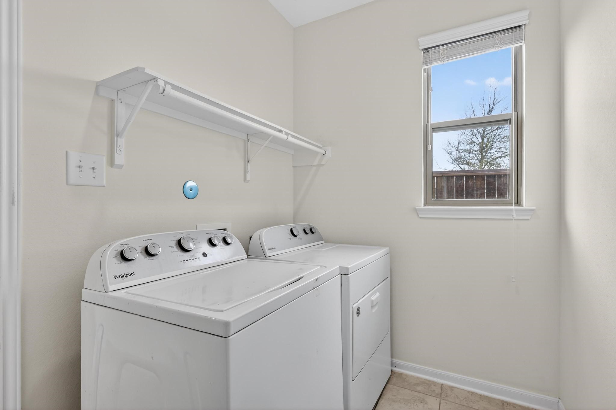 3322 Nila Creek Dr Spring Spring, TX 77373 - Photo 13 of 36 Laundry room with washer and dryer connections and built-in shelving for convenient storage and organization.