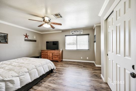 725 West Howell Avenue Ridgecrest, CA 93555 - Photo 29 of 35 a bedroom with a bed and a flat screen tv