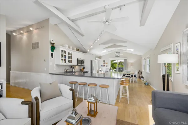 a living room with lots of furniture and kitchen view