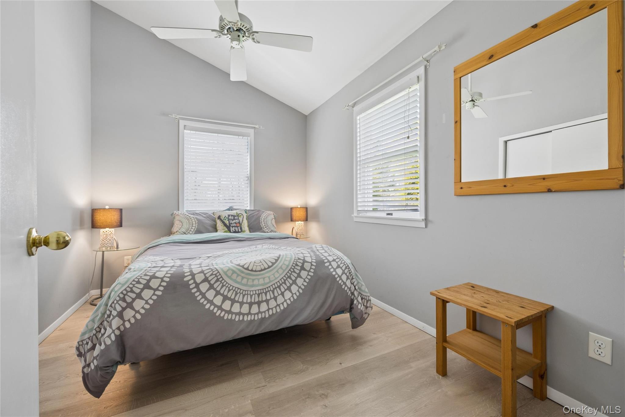 57 Kyle Road Hampton Bays, NY 11946 - Photo 11 of 19 a bedroom with a bed and a chandelier