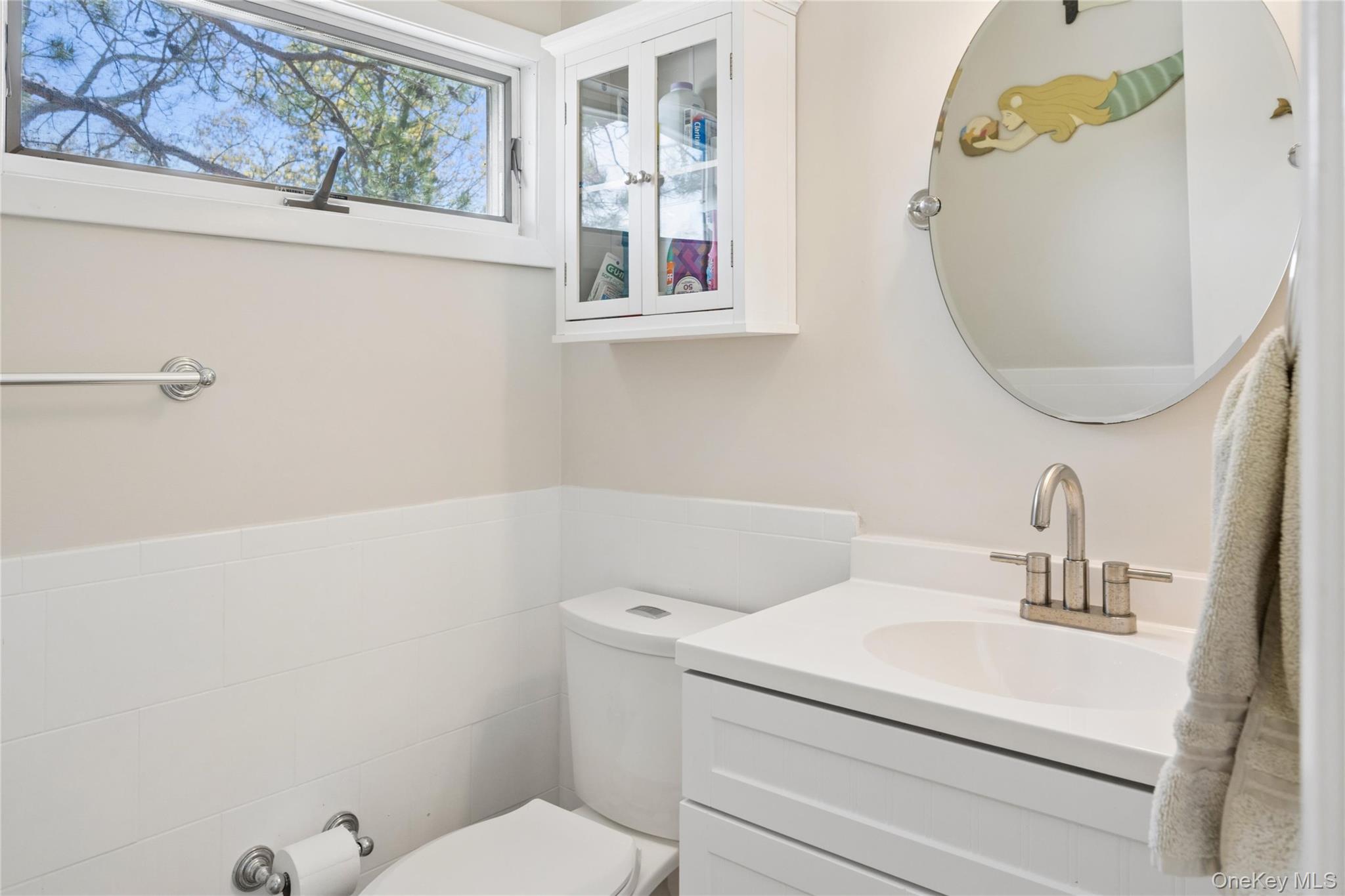 57 Kyle Road Hampton Bays, NY 11946 - Photo 12 of 19 a bathroom with a sink and a mirror