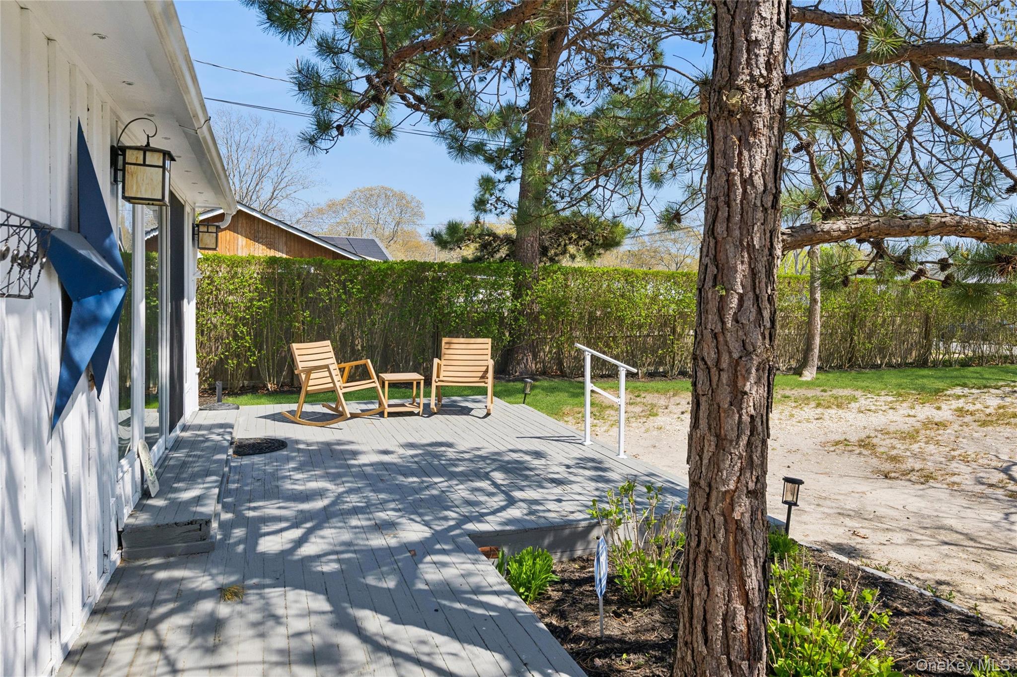 57 Kyle Road Hampton Bays, NY 11946 - Photo 14 of 19 a view of a chair and table in backyard of the house
