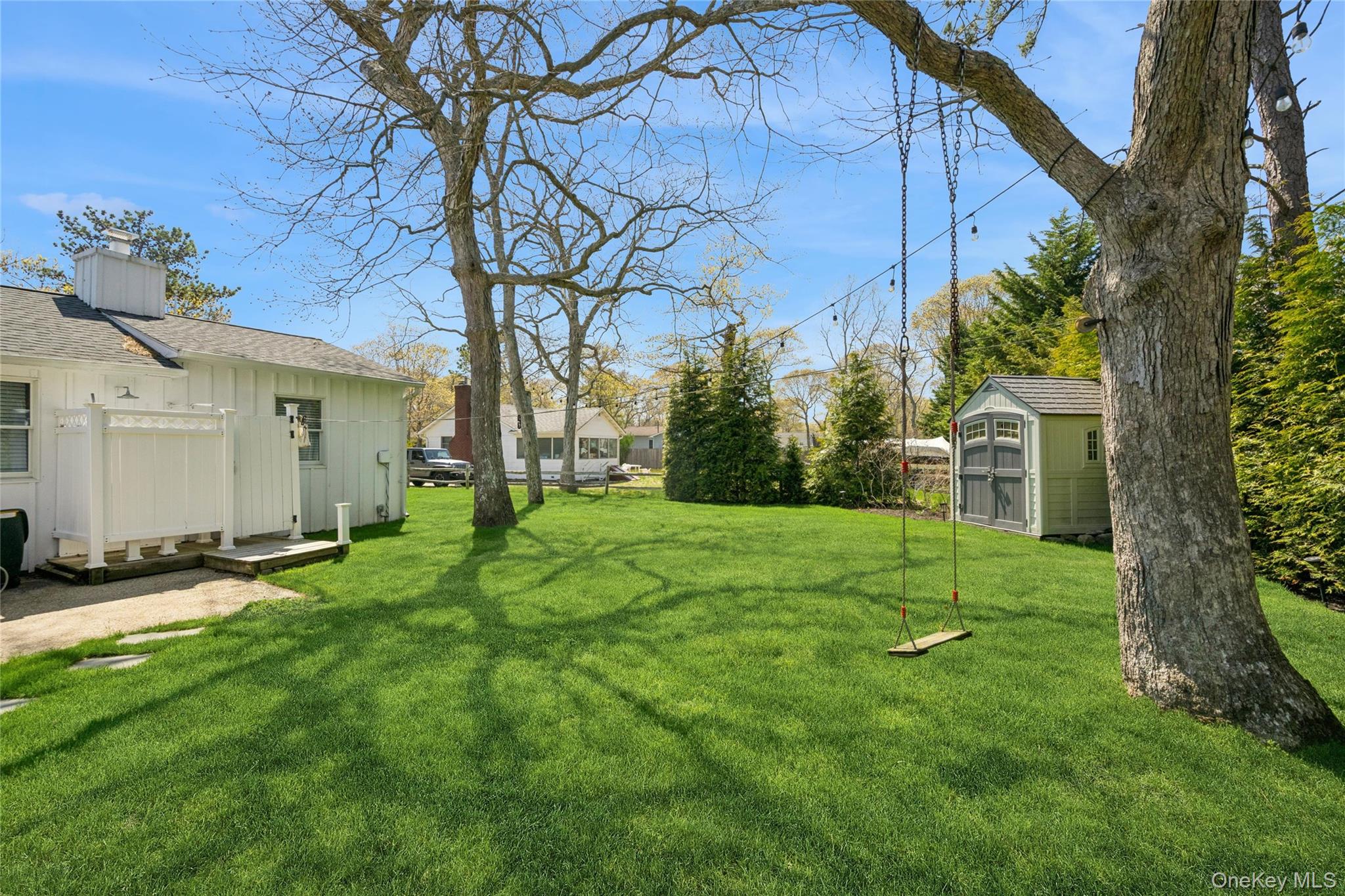 57 Kyle Road Hampton Bays, NY 11946 - Photo 15 of 19 a view of a backyard with plants and large trees