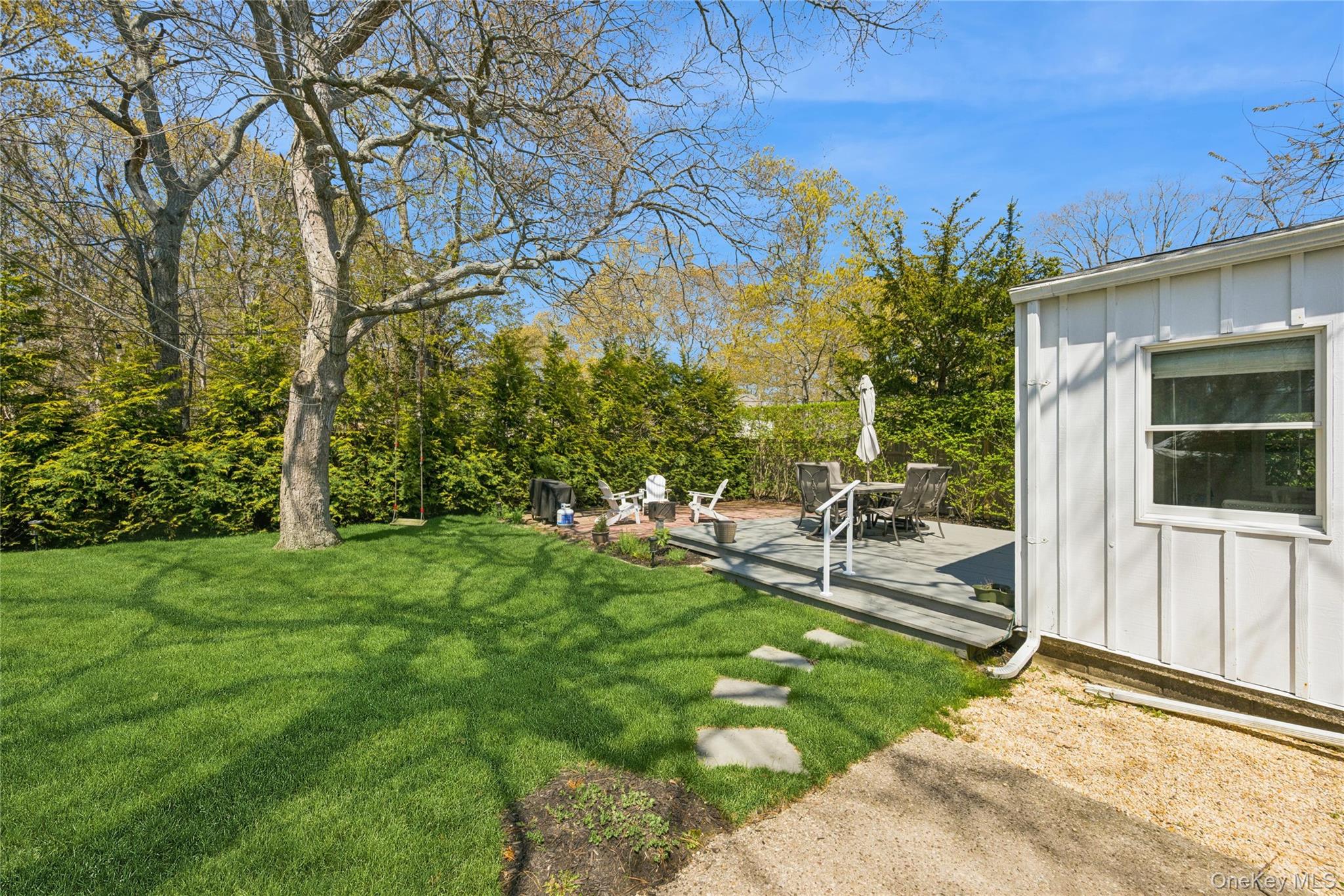 57 Kyle Road Hampton Bays, NY 11946 - Photo 17 of 19 a view of a backyard with a patio