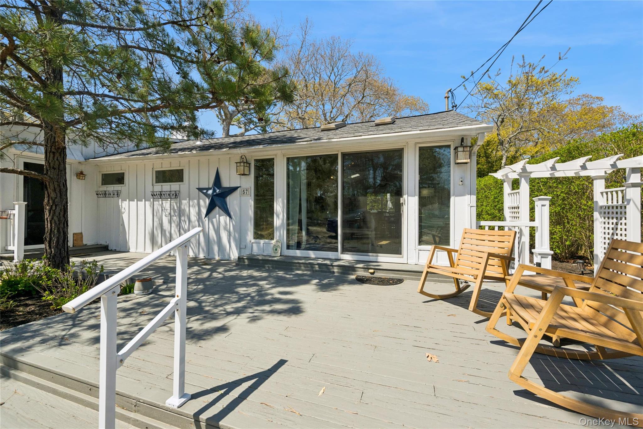 57 Kyle Road Hampton Bays, NY 11946 - Photo 3 of 19 a wooden bench sitting in front of a building