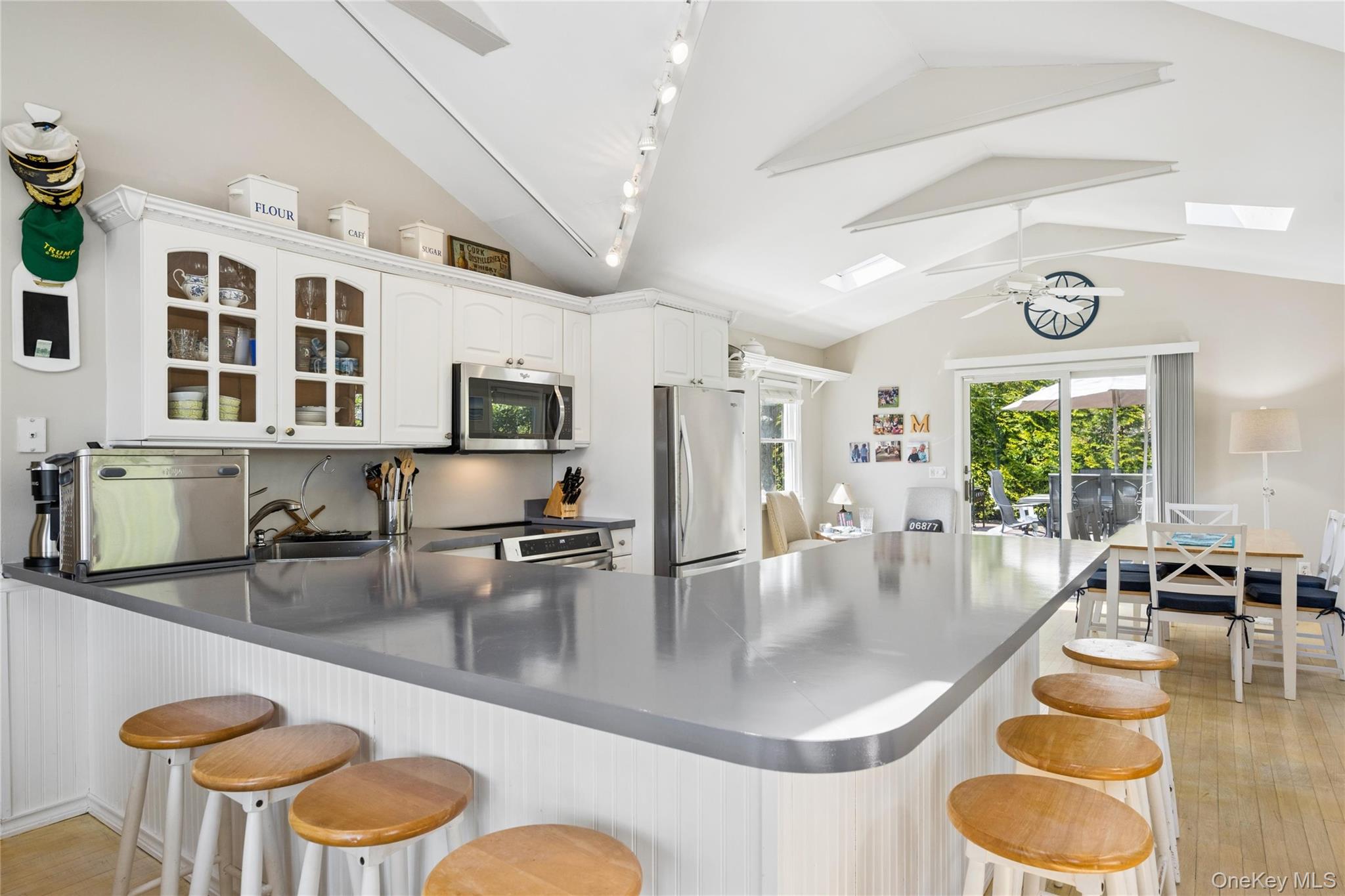 57 Kyle Road Hampton Bays, NY 11946 - Photo 4 of 19 a kitchen with a dining table and chairs