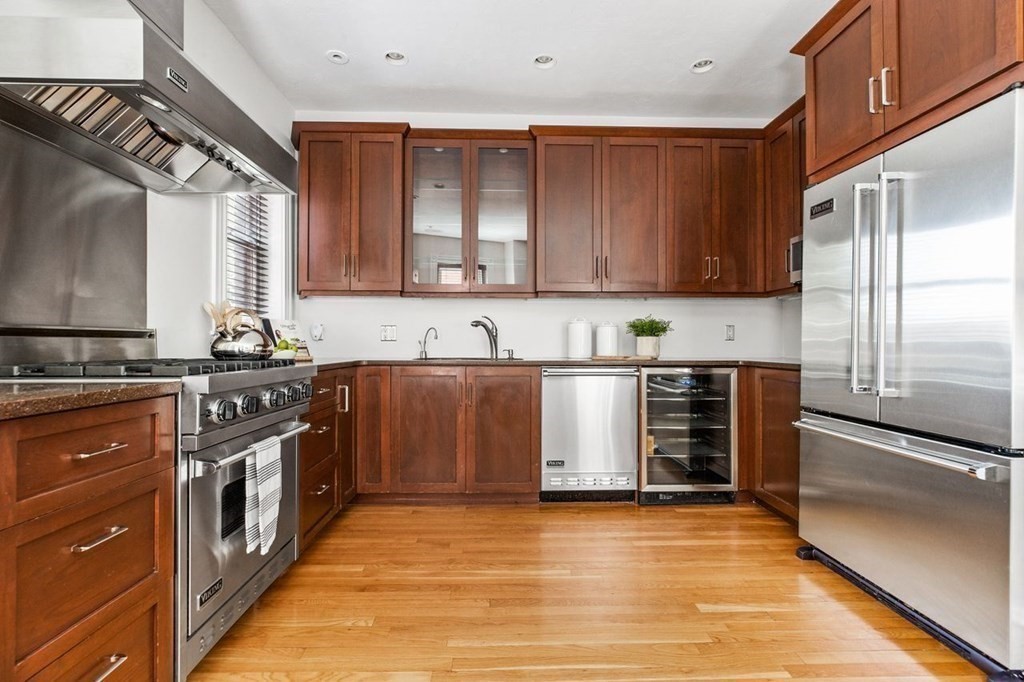 1 Clinton Path, Unit 2 Brookline, MA 02445 - Photo 11 of 28 a kitchen with stainless steel appliances granite countertop a stove a sink and a refrigerator