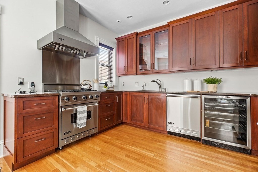 1 Clinton Path, Unit 2 Brookline, MA 02445 - Photo 12 of 28 a kitchen with stainless steel appliances granite countertop a stove a sink and a microwave